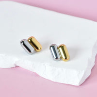 Stylish dual-tone capsule stud earrings in gold and silver