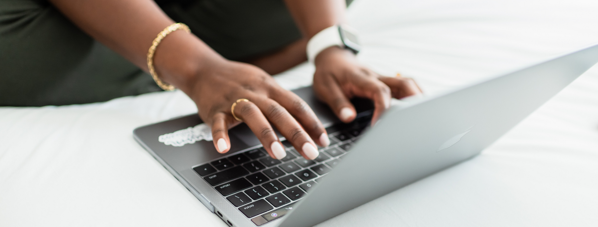 Hands typing on laptop