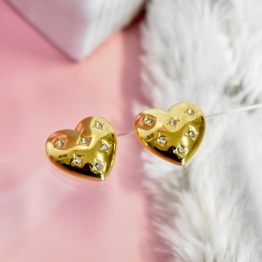 Elegant golden heart-shaped stud earrings adorned with sparkling diamond accents