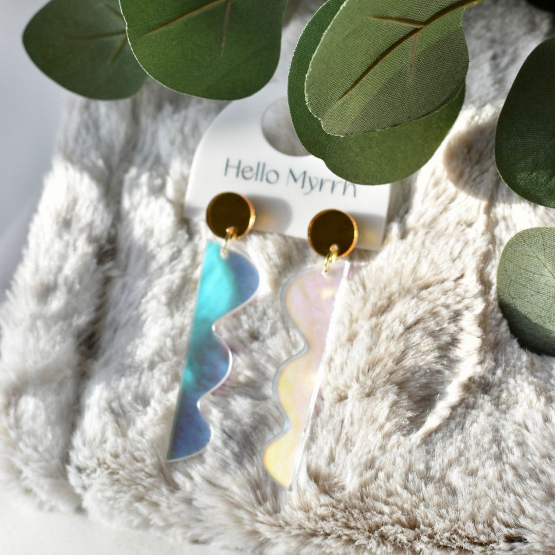 Kazi Iridescent/Gold earrings with shimmering iridescent design and gold accents.