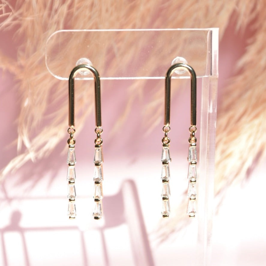 Elegant gold linear drop earrings featuring sparkling crystal accents