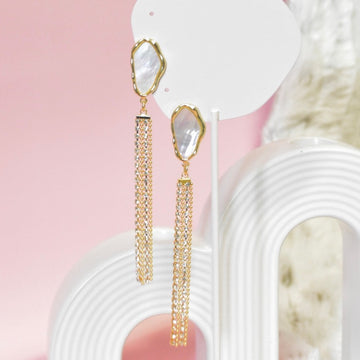 Chic pearl drop earrings featuring gold chain tassels