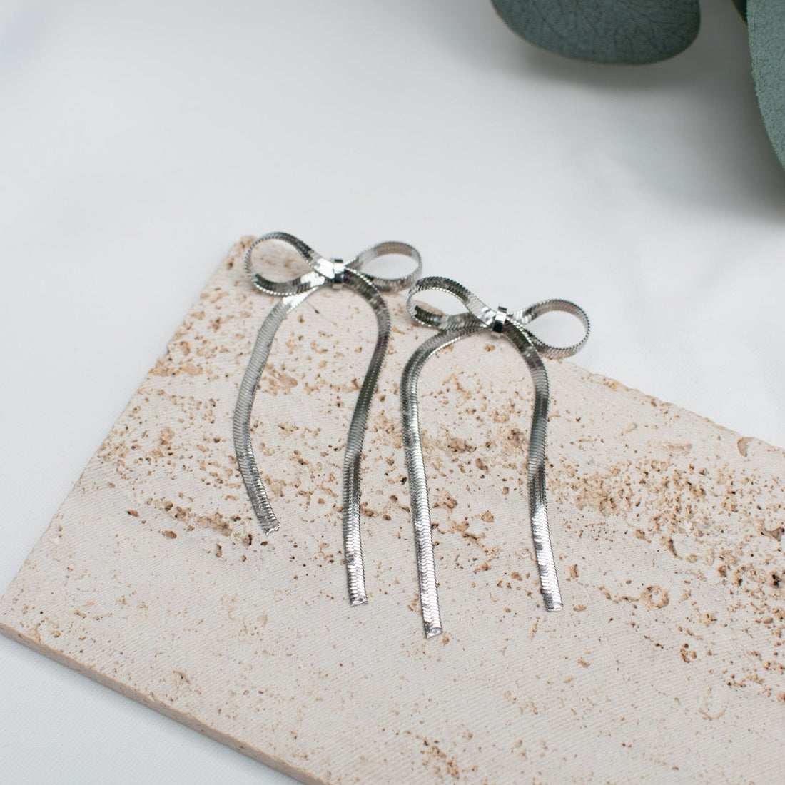 Silver Bow shaped snake chain dangle earrings 