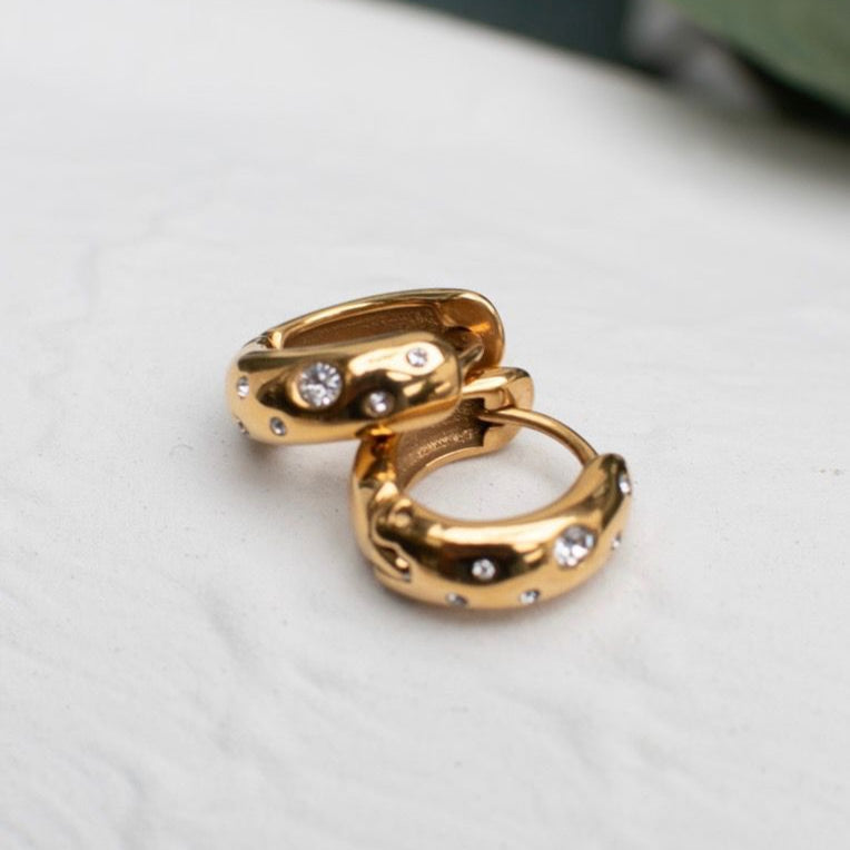 Gold hoop earrings with sparkling stones from the Galentine Collection.