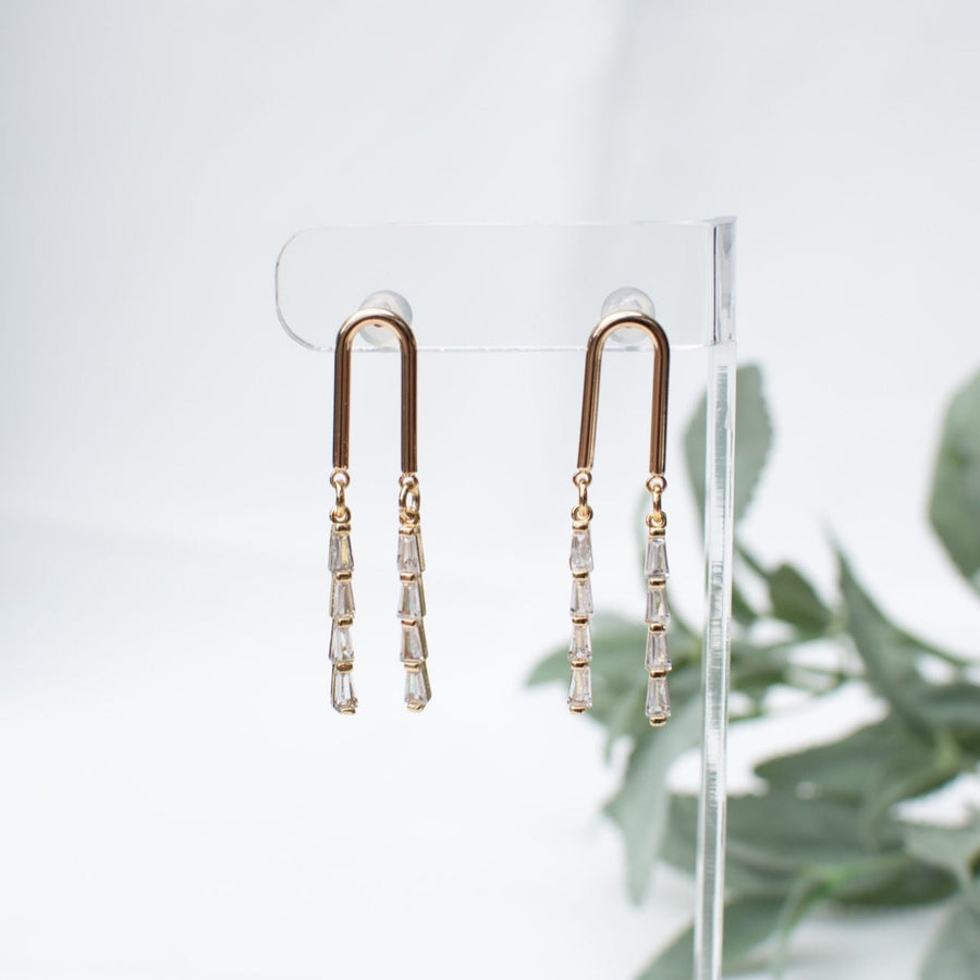 Elegant gold linear drop earrings featuring sparkling crystal accents