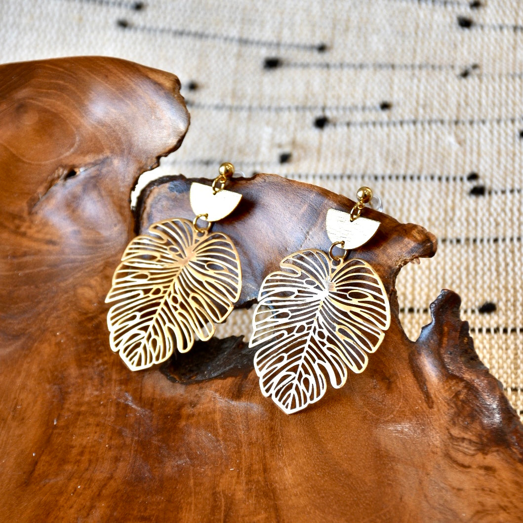 Intricate gold monstera leaf earrings with a delicate, openwork design